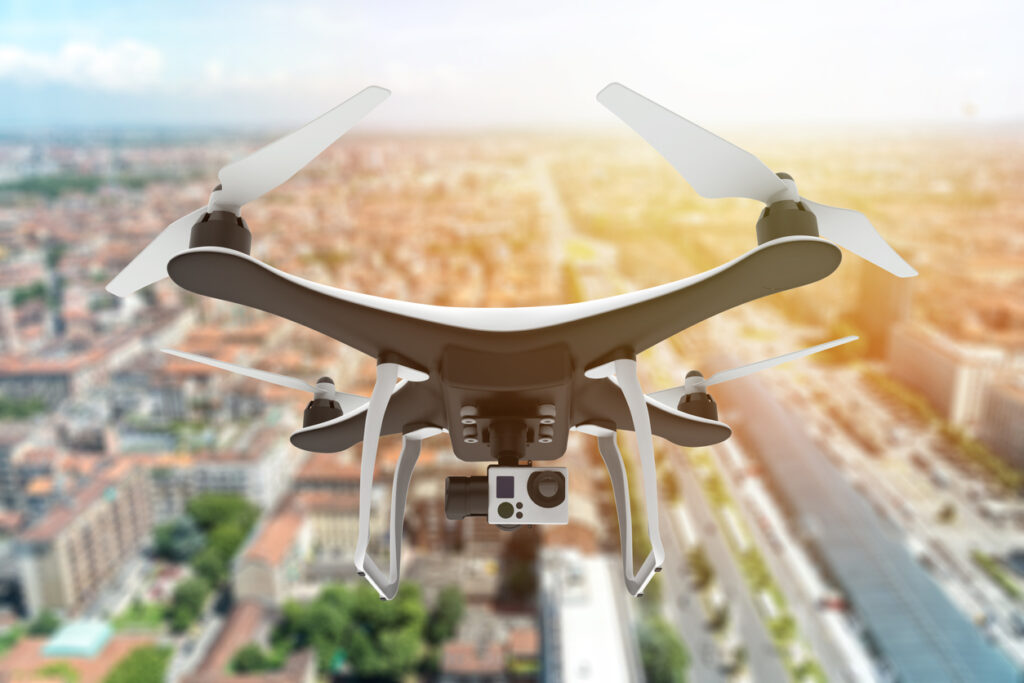 Drone with digital camera flying over a city